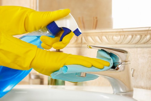 Local upholstery cleaner treating stains on a lounge armchair