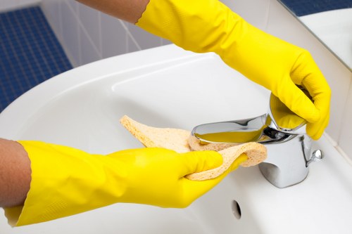 Technician using safe chemical handling practices during carpet cleaning
